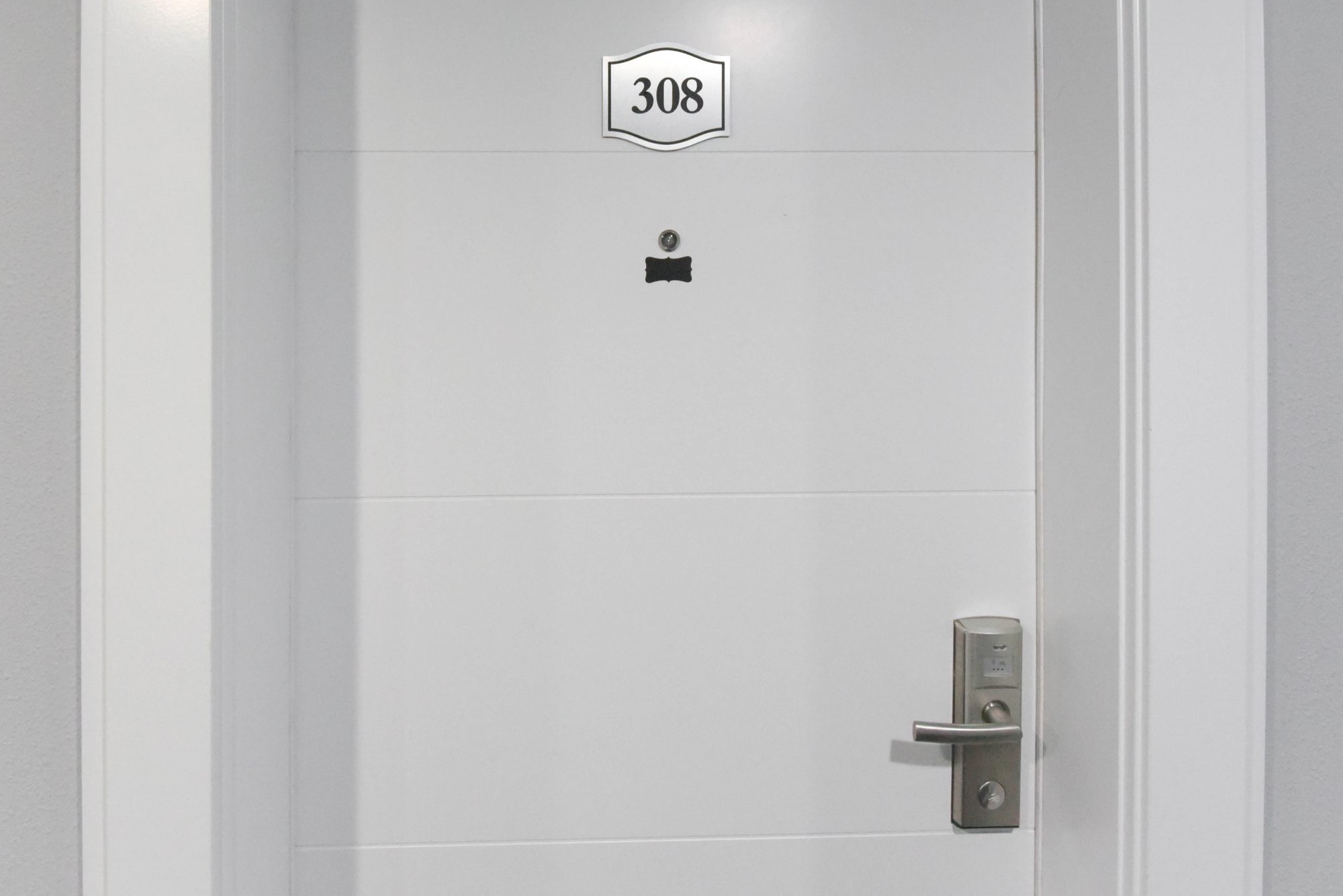 Entry door of a one bedroom suite with in-suite laundry at The Metro 1827
