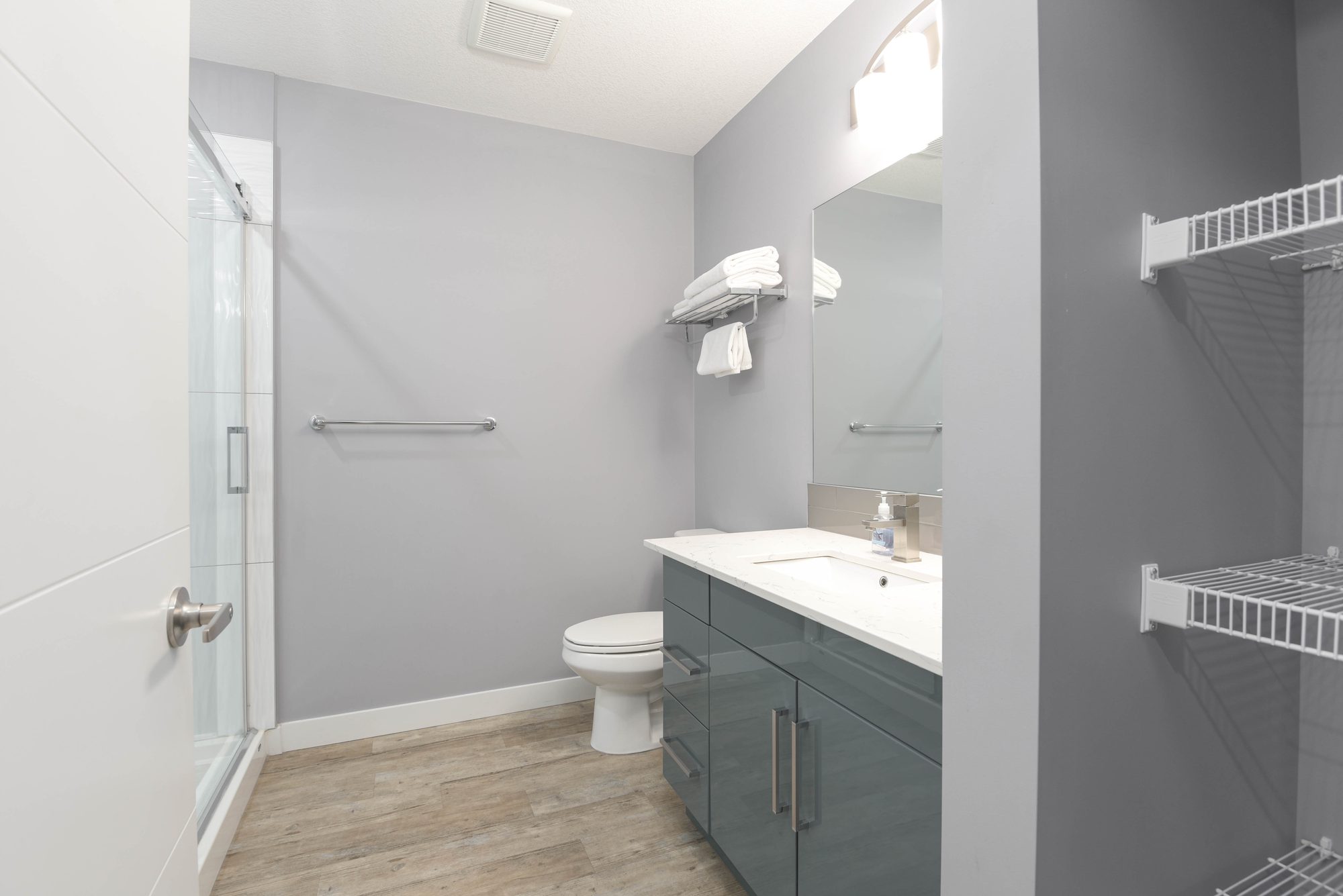 Bathroom vanity with quartz countertop next to the suite's kitchenette
