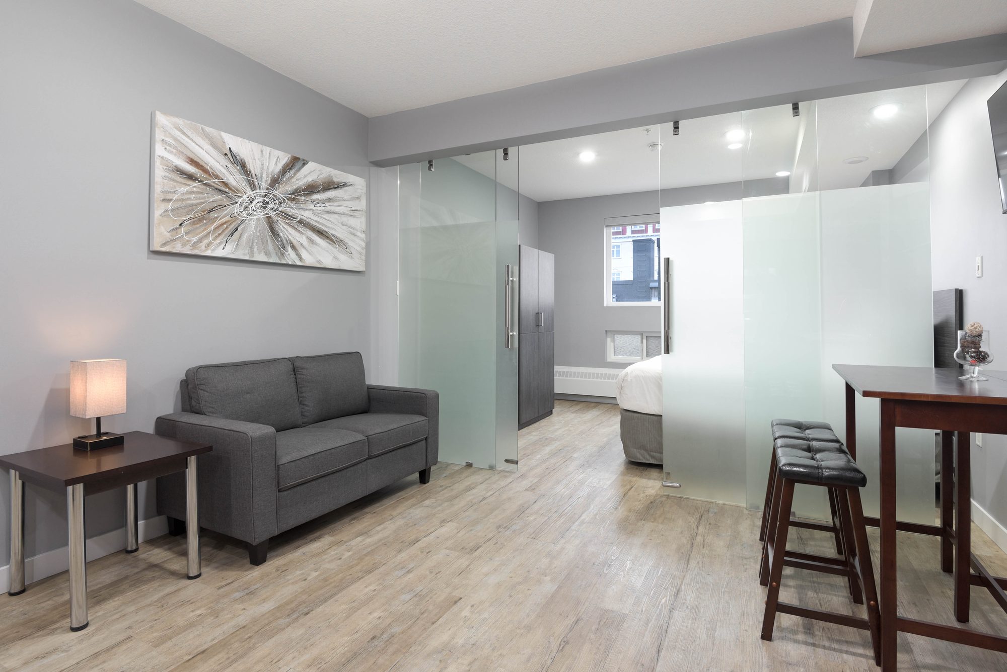 Kitchen with breakfast bar seating, stainless steel refrigerator, and range