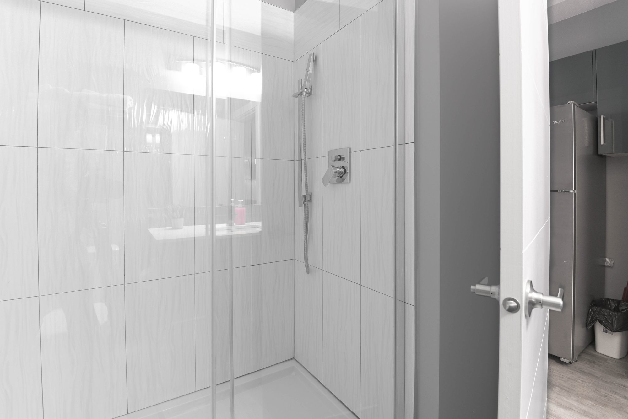 Tiled walk-in shower in a studio suite bathroom